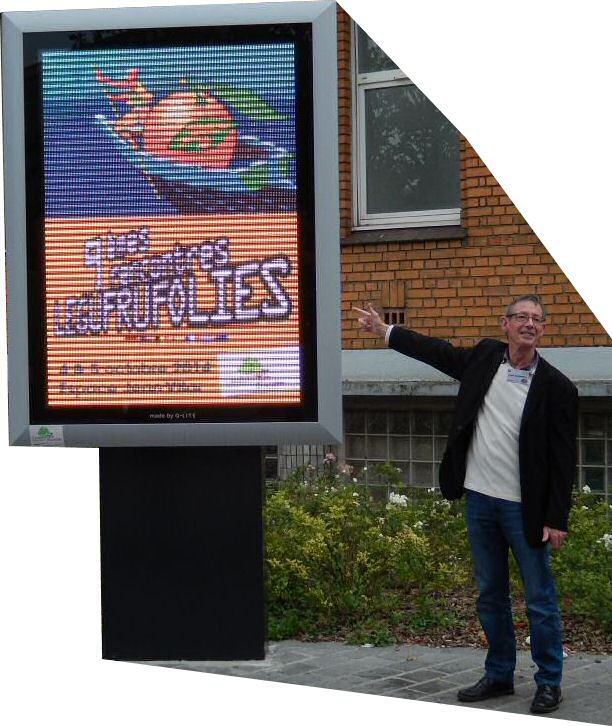 Alain, devant le panneau lumineux affichant sa création